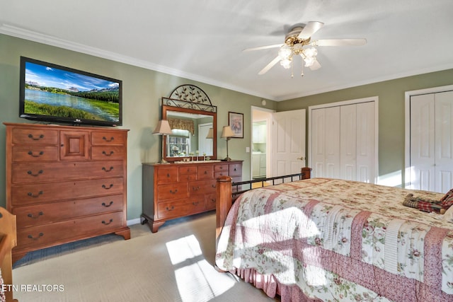 bedroom featuring a ceiling fan, light carpet, two closets, and crown molding