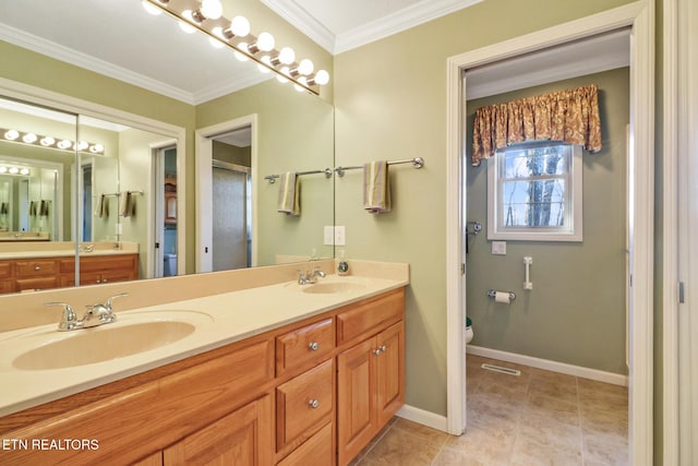 full bath featuring a sink, baseboards, ornamental molding, and tile patterned flooring