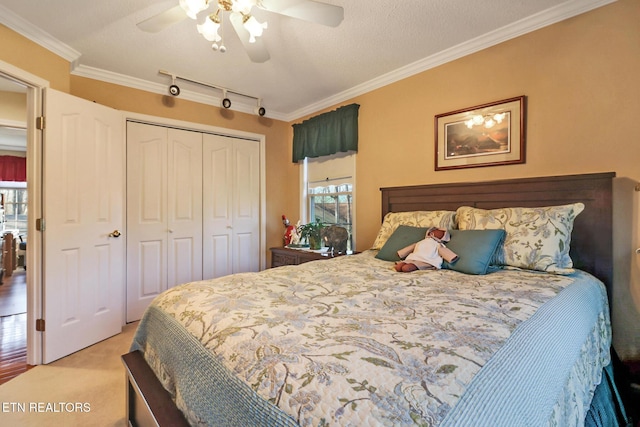 bedroom featuring a closet, light colored carpet, ceiling fan, and ornamental molding