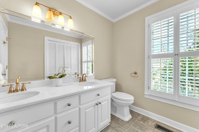 bathroom featuring crown molding, plenty of natural light, and a sink