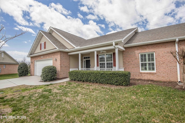 view of front facade featuring brick siding, covered porch, a front yard, and a garage