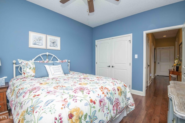 bedroom featuring a closet, dark wood finished floors, a ceiling fan, and baseboards