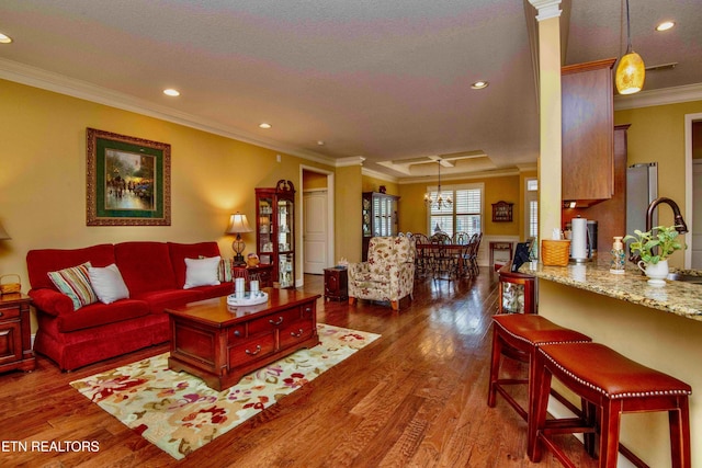 living room featuring recessed lighting, wood finished floors, and ornamental molding