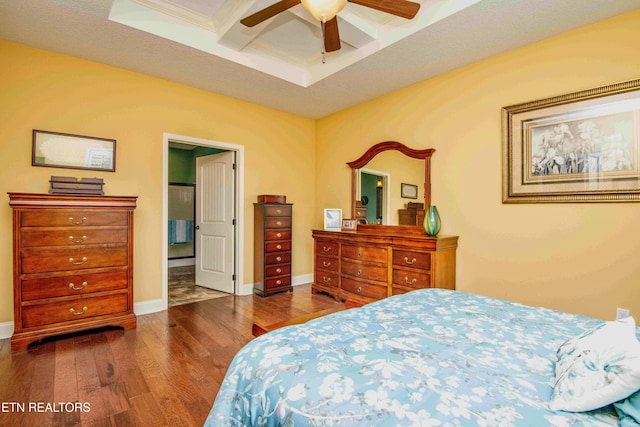 bedroom featuring baseboards, coffered ceiling, beamed ceiling, wood finished floors, and ceiling fan