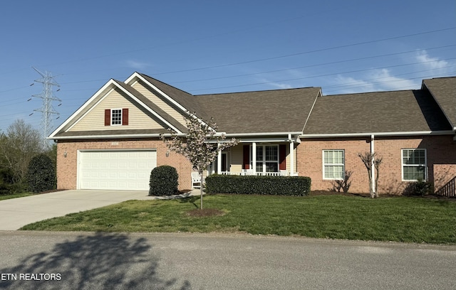view of front of house with driveway, brick siding, a front yard, and a garage