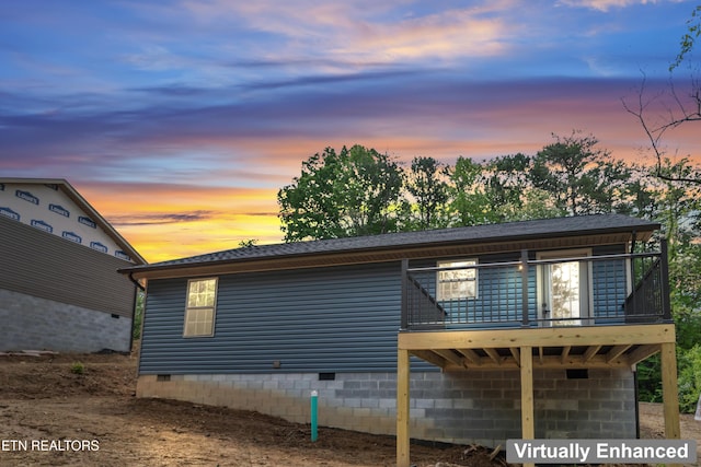 property exterior at dusk featuring crawl space