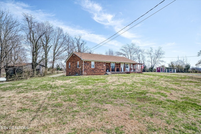 ranch-style home with a front yard and brick siding