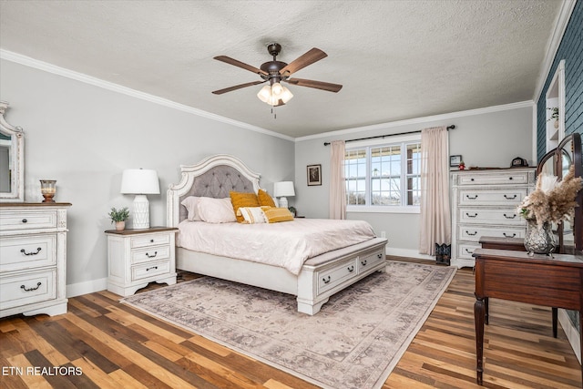 bedroom featuring a textured ceiling, wood finished floors, and ornamental molding