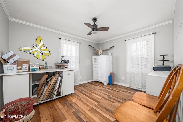 office area featuring baseboards, wood finished floors, a ceiling fan, and crown molding