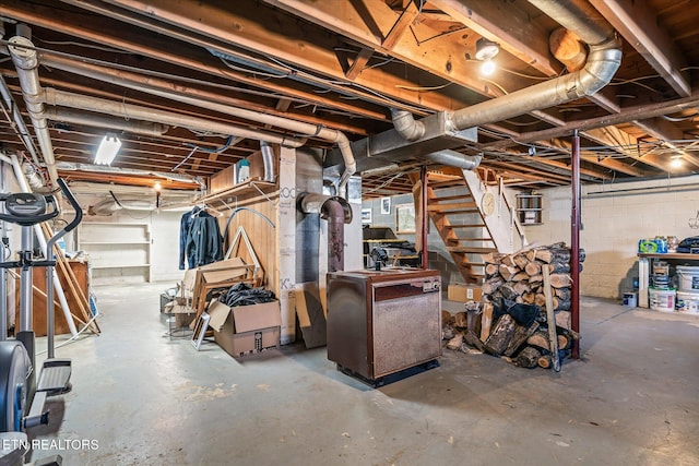 unfinished basement featuring stairs