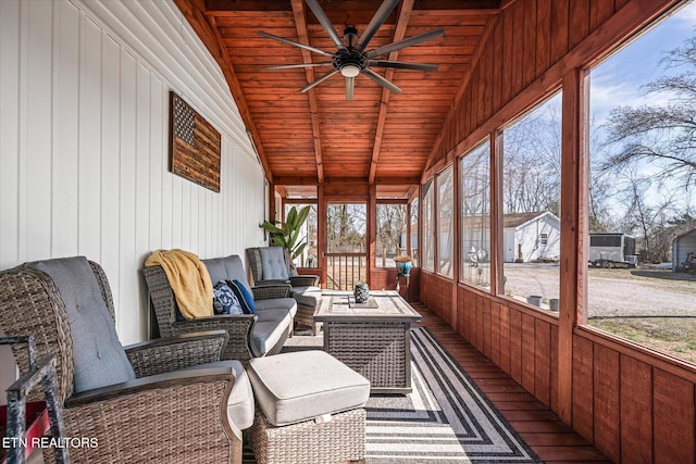 sunroom / solarium with vaulted ceiling with beams, wood ceiling, and ceiling fan