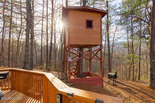 wooden deck with a forest view