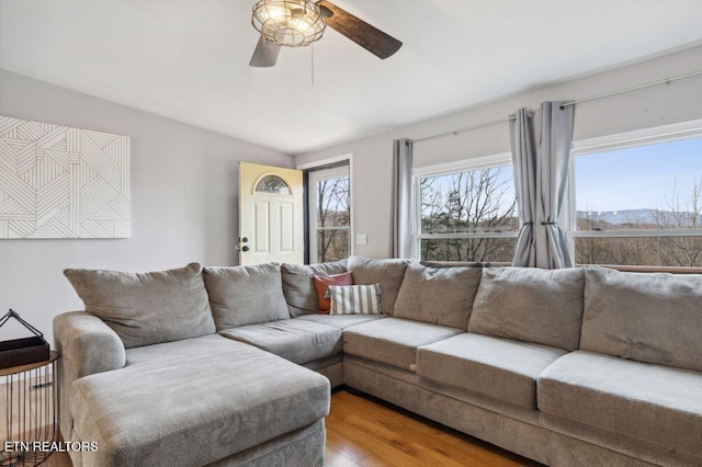 living area featuring wood finished floors and ceiling fan