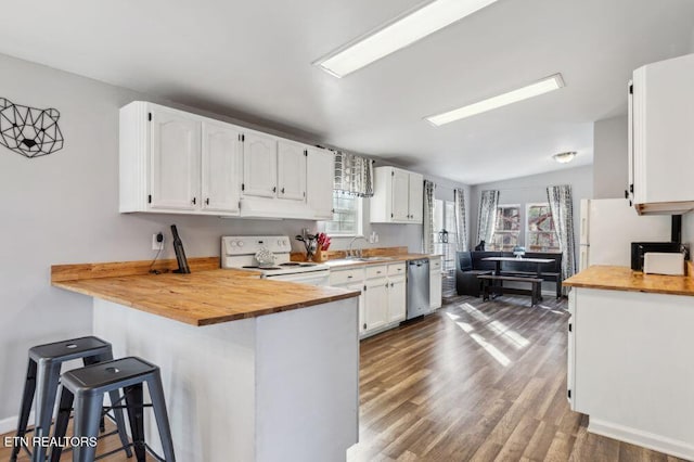 kitchen featuring white cabinets, white appliances, and butcher block counters