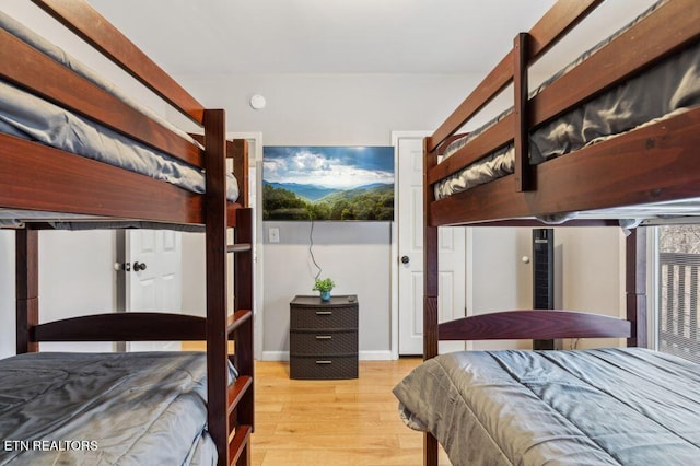 bedroom with baseboards and wood finished floors