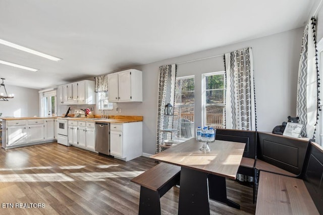 kitchen featuring electric range, wood finished floors, a peninsula, white cabinets, and dishwasher