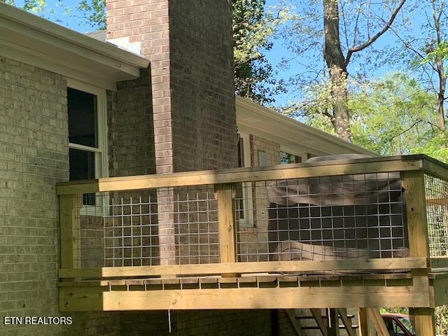 view of side of property with brick siding and a chimney