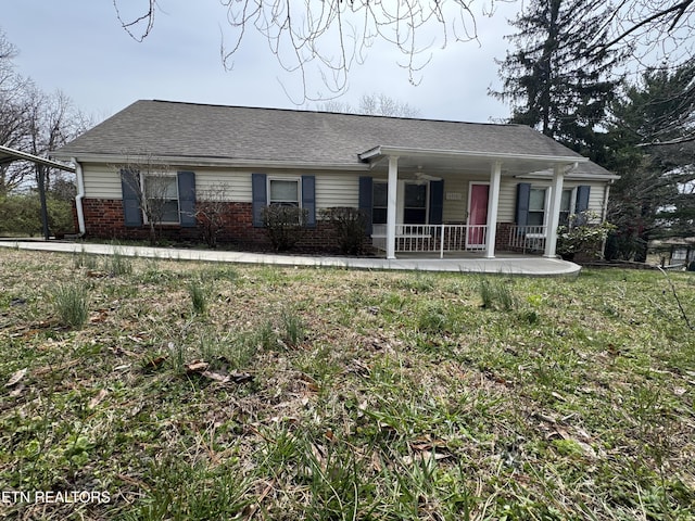 single story home with brick siding, covered porch, and roof with shingles