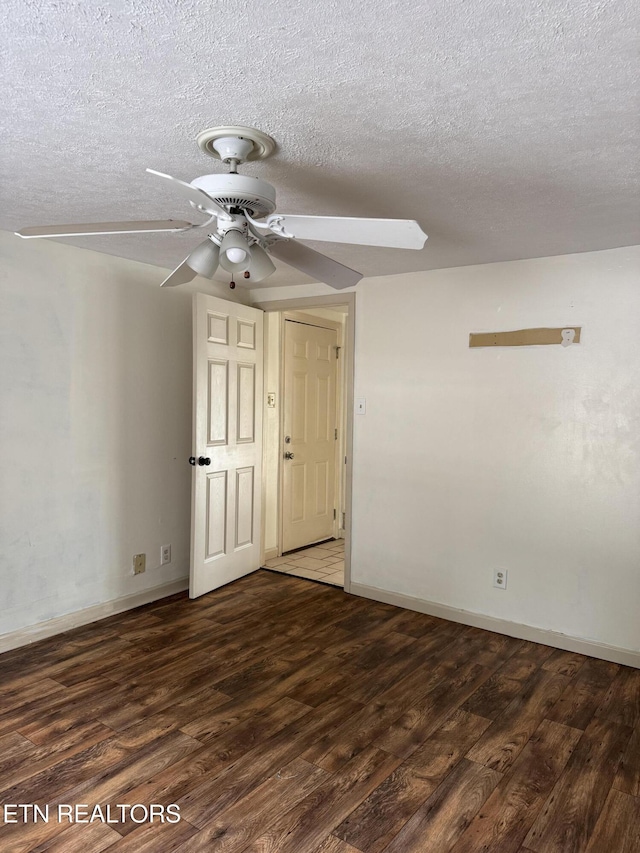 spare room featuring baseboards, a textured ceiling, a ceiling fan, and wood finished floors