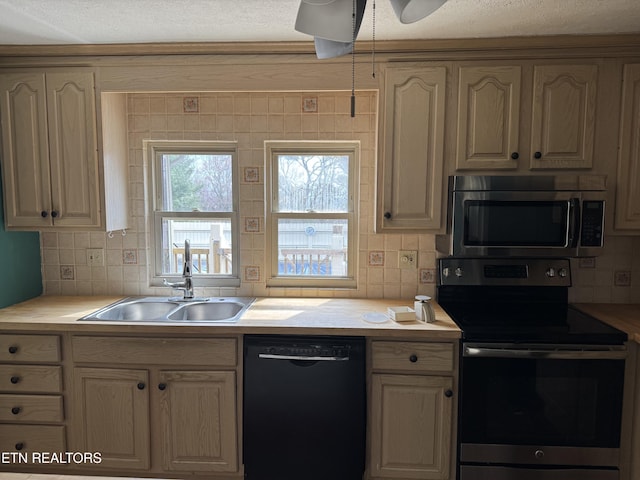 kitchen featuring electric range, a sink, light countertops, black dishwasher, and stainless steel microwave