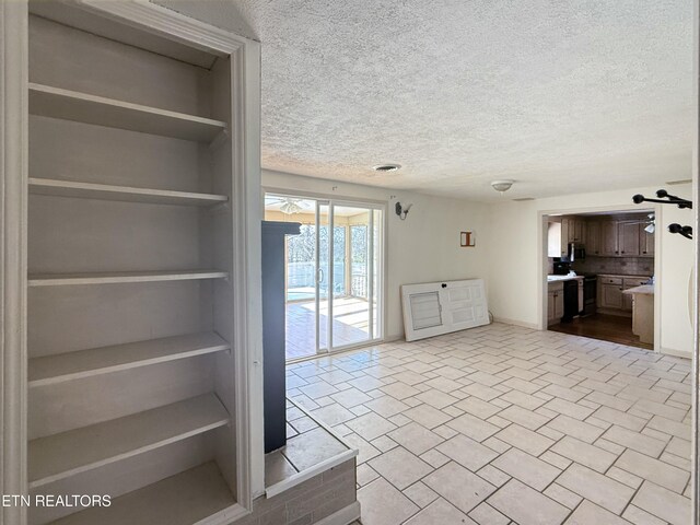 unfurnished living room with a textured ceiling