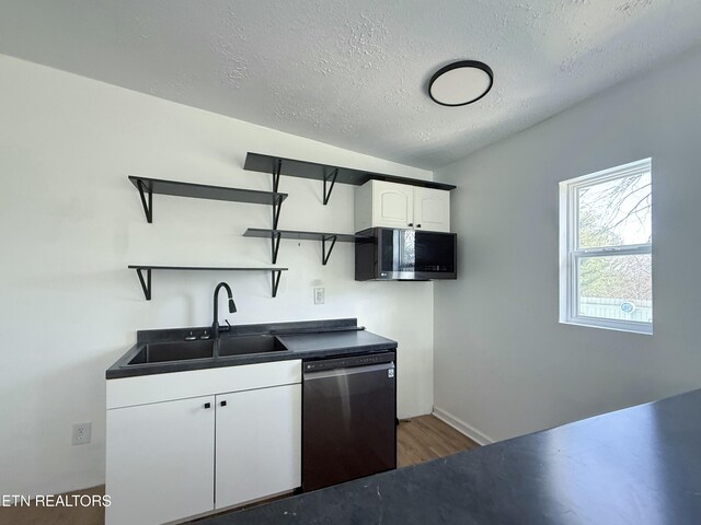 kitchen with a sink, open shelves, dark countertops, and appliances with stainless steel finishes