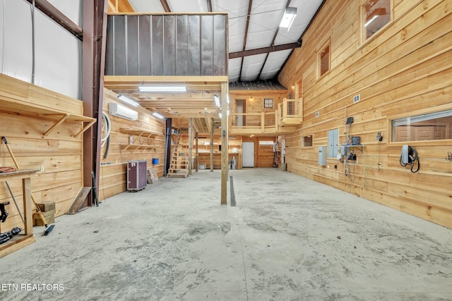 garage with wood walls and a wall unit AC