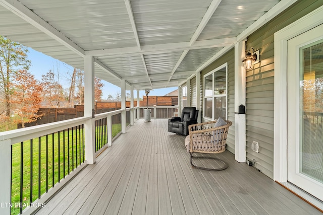 deck with a lawn and fence