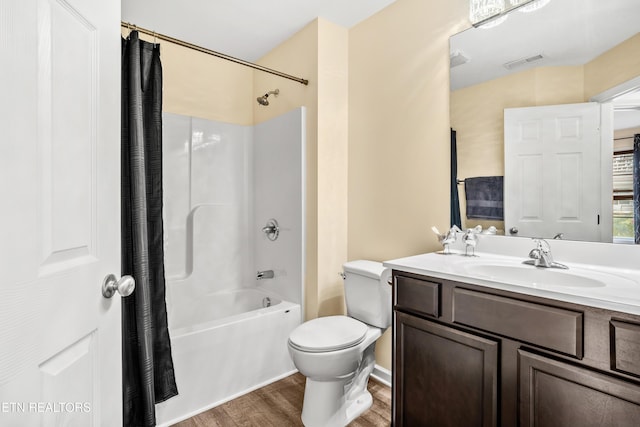 full bathroom with visible vents, toilet, shower / bath combo, wood finished floors, and vanity