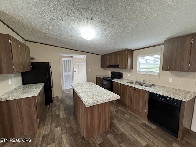 kitchen with a kitchen island, black appliances, dark wood-type flooring, and a sink