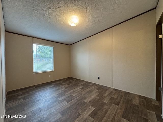 empty room featuring a textured ceiling, wood finished floors, and ornamental molding