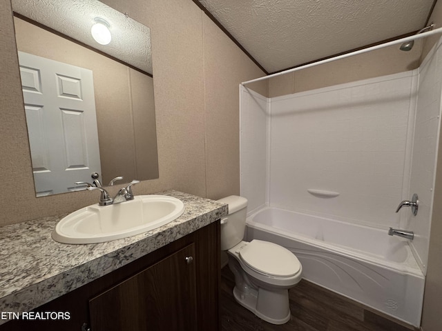 bathroom featuring toilet, a textured ceiling, wood finished floors, bathtub / shower combination, and vanity