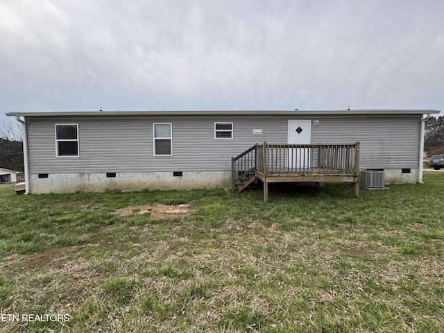 rear view of house with a wooden deck, central AC unit, a lawn, and crawl space