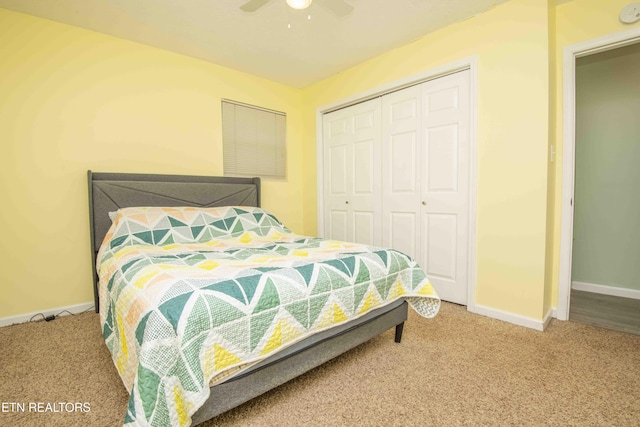 bedroom with a closet, baseboards, carpet, and a ceiling fan