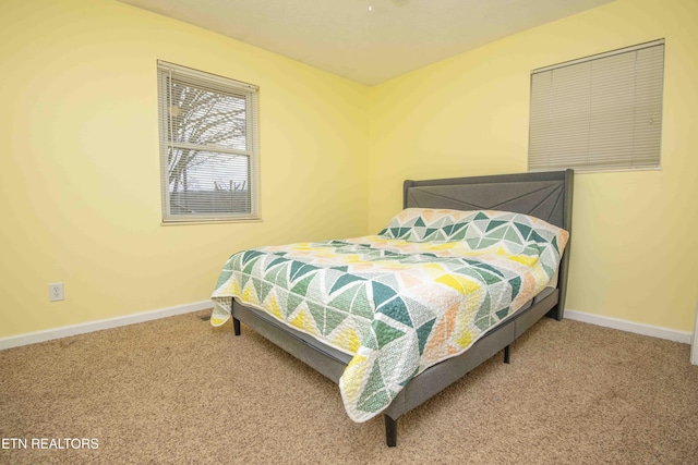 carpeted bedroom featuring baseboards