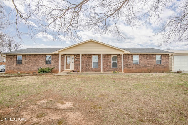 single story home featuring brick siding, an attached garage, and a front yard