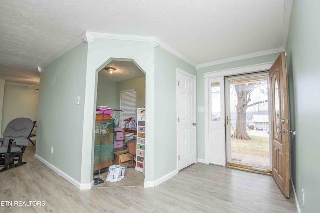 252 Chapman Overlook Dr, Seymour, TN 37865 - entryway featuring light wood-style floors, ornamental molding, baseboards, arched walkways, and a textured ceiling