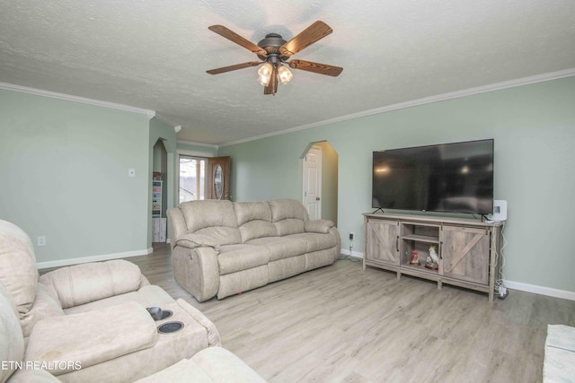 living area with baseboards, wood finished floors, a textured ceiling, and ceiling fan