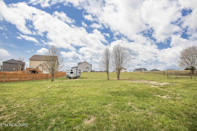 view of yard with a rural view and fence