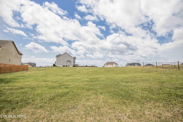 view of yard featuring a rural view and fence