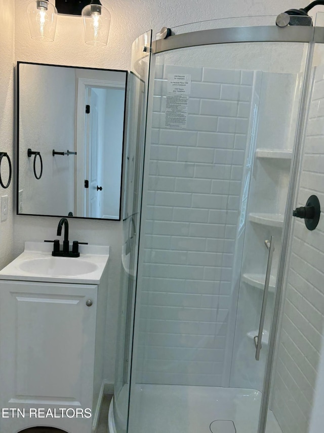 full bathroom featuring vanity and a stall shower