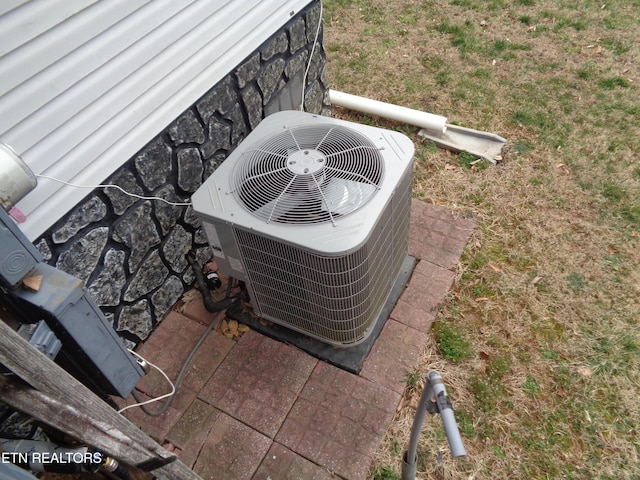 details featuring stone siding and central AC