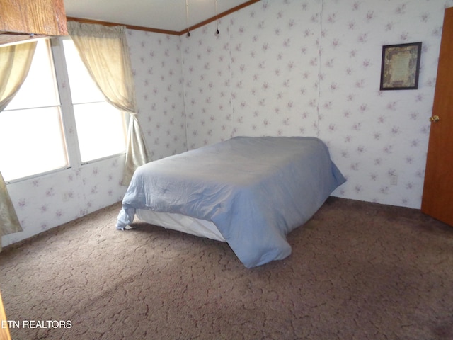 bedroom featuring carpet, ornamental molding, and wallpapered walls