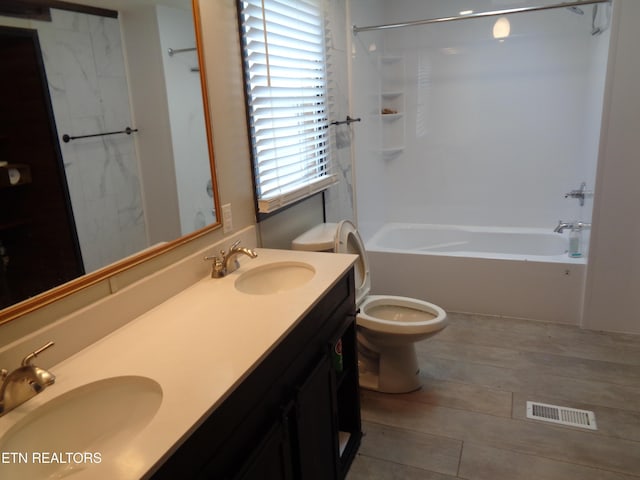 full bath with visible vents, shower / washtub combination, toilet, and a sink