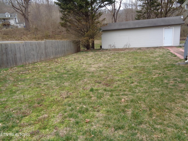 view of yard with an outdoor structure and fence