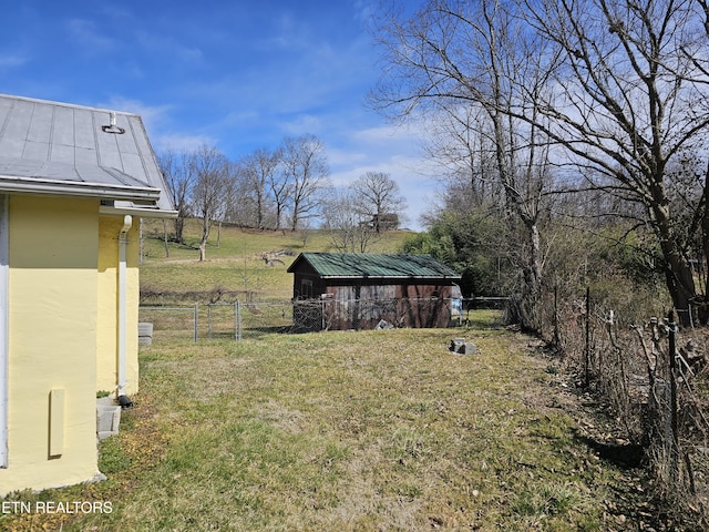 view of yard featuring an outdoor structure and fence