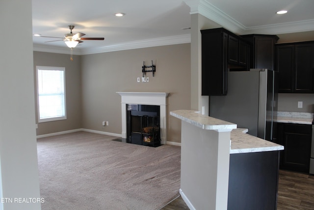 kitchen with a ceiling fan, crown molding, light countertops, and freestanding refrigerator