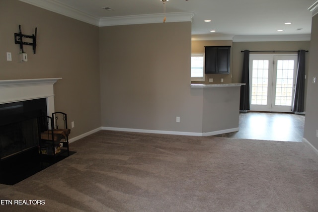 unfurnished living room with a fireplace with flush hearth, baseboards, carpet floors, and ornamental molding