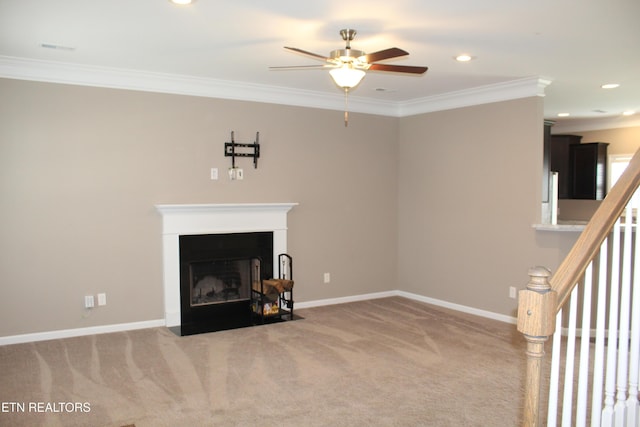 unfurnished living room with baseboards, a fireplace with flush hearth, carpet floors, ornamental molding, and a ceiling fan