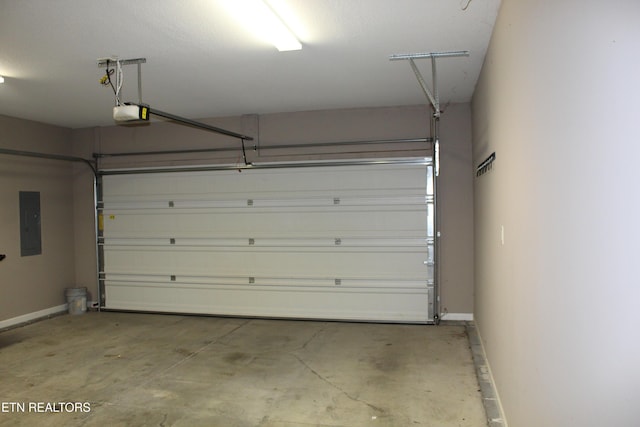 garage featuring electric panel, baseboards, and a garage door opener